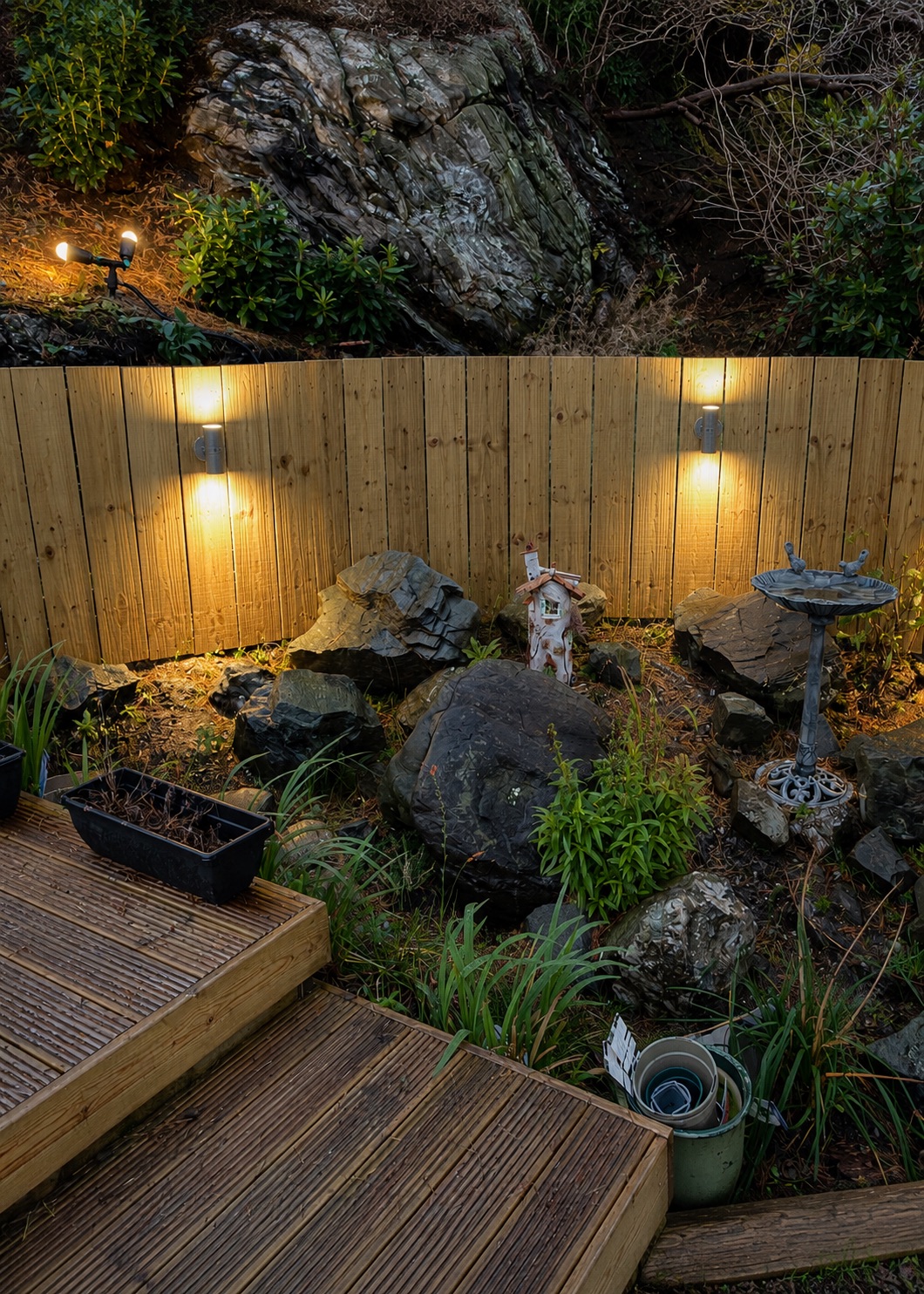 Outdoor garden lighting installed by Dreamy Electrics, illuminating a landscaped garden with feature wall lights and uplighting in Helensburgh